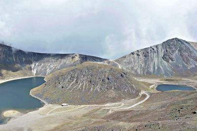 Scenic view of mountains against cloudy sky