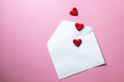 Directly above shot of heart shapes on pink background