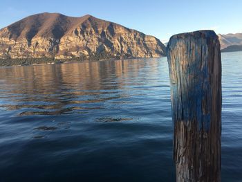 Scenic view of sea and mountains against sky