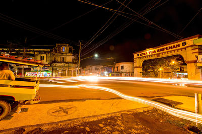 Light trails on road in city at night