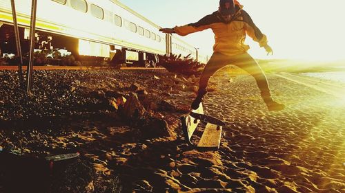 Man jumping on road against sky