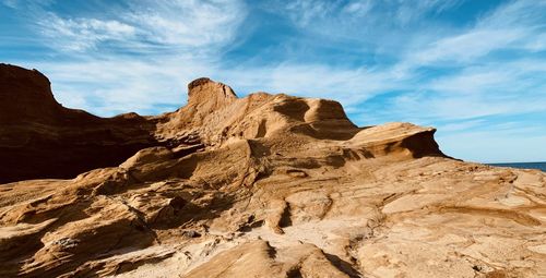 Low angle view of rock formations against sky