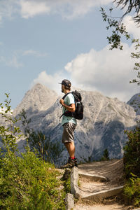 Full length of man standing on mountain against sky