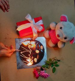 High angle view of hand holding toys on table