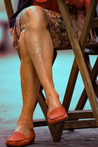 Low section of woman standing on wood