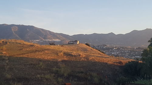 Scenic view of landscape and mountains against sky