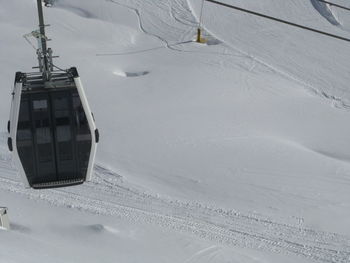 Ski lift over snow covered field