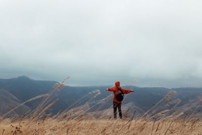 Rear view of man standing on mountain