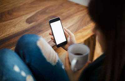 Man holding smart phone at home