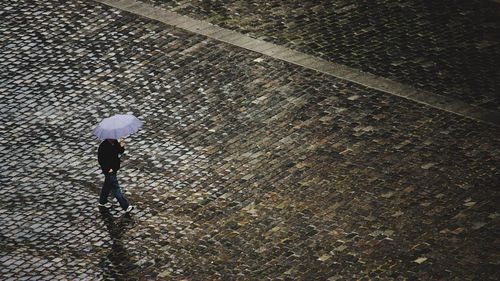 Low section of woman walking on bridge