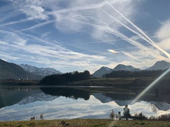 Scenic view of lake and mountains against sky