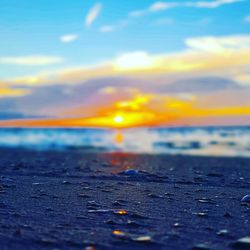 Close-up of sea against sky at sunset