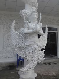 Statue of buddha against building