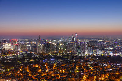Aerial view of city lit up at night