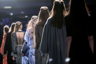 Rear view of women standing in corridor