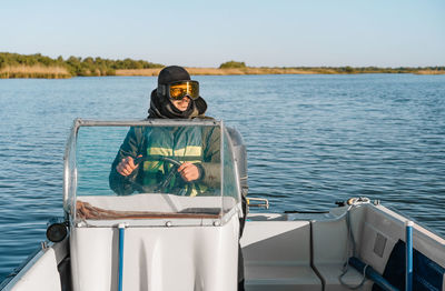 Smiling man driving boat in danube delta