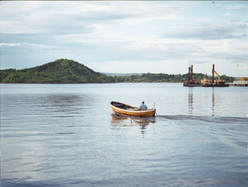 Boat in river against sky