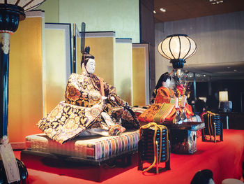 Statue of toys on table at illuminated store