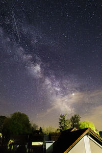 Low angle view of trees against sky at night