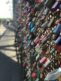 Low angle view of padlocks hanging on railing