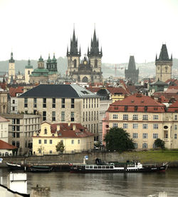 River amidst buildings in city against sky