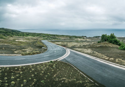 Road by sea against sky