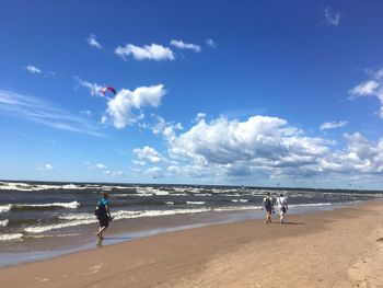 People on beach against sky