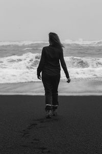 Lady spending time on black beach monochrome scenic photography