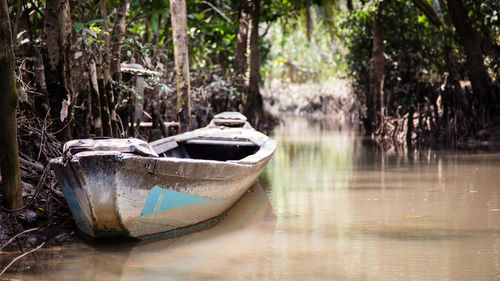 Abandoned boat moored in lake