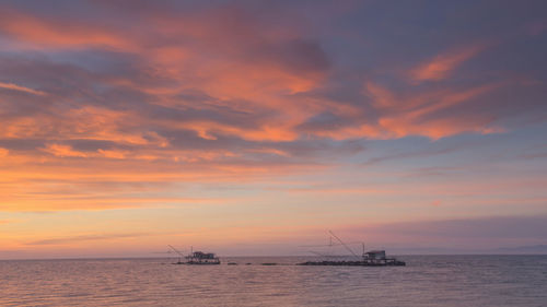 Scenic view of sea against orange sky