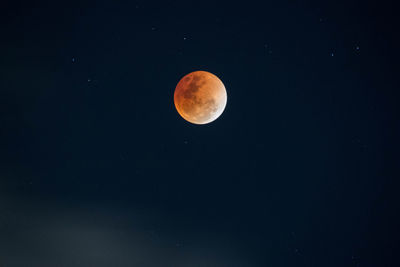 Low angle view of moon against clear sky at night