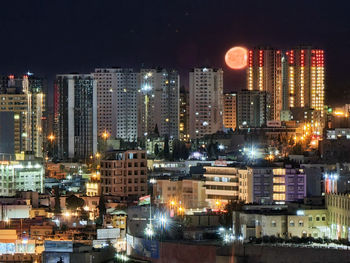 Illuminated buildings in city at night