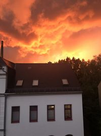 Low angle view of building against orange sky