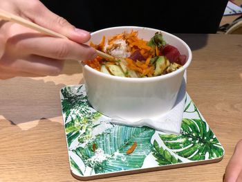 Close-up of person holding food on table