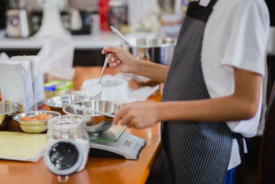 Midsection of man working at table