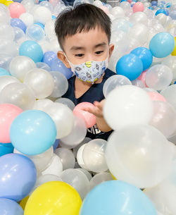 Boy playing with colourful balls