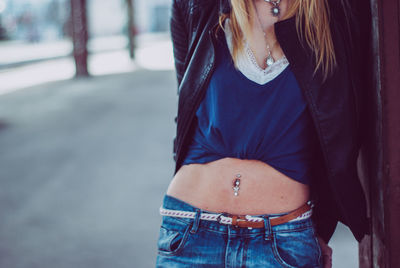 Midsection of woman standing on railroad station platform