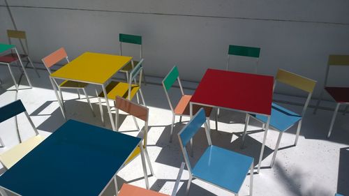 High angle view of empty tables and chairs at cafe