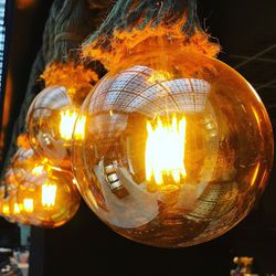 Close-up of illuminated lamp hanging at night