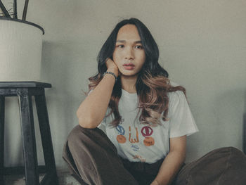 Portrait of woman sitting at home