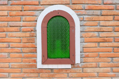 Close-up of window on brick wall