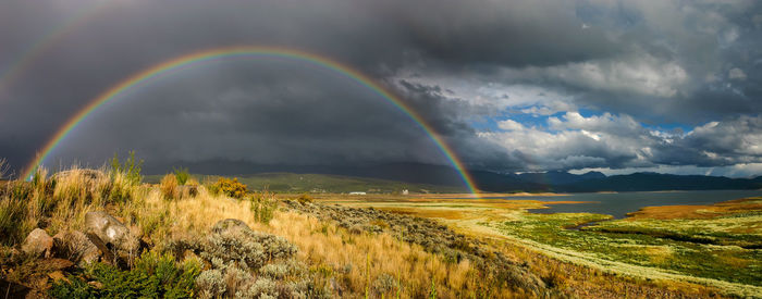 Rainbow over landscape against sky