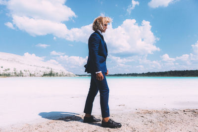 Full length of man standing on land against sky