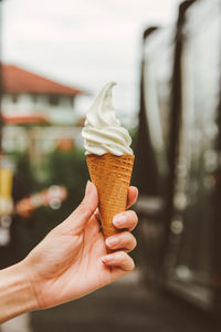Cropped hand of woman holding ice cream cone
