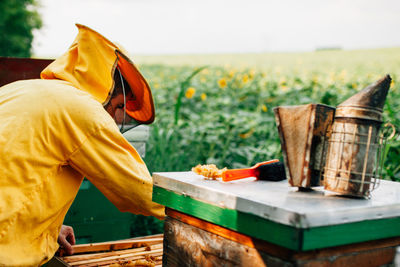 Side view of man working on field