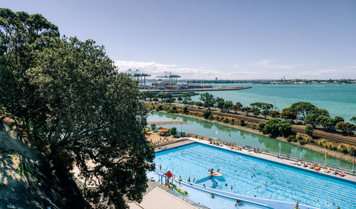 High angle view of swimming pool by sea against sky