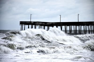 Pier in sea against sky