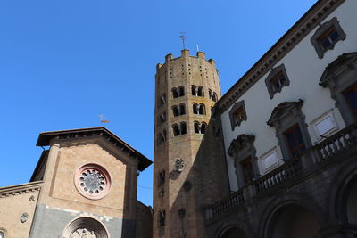 Low angle view of clock tower against sky in city