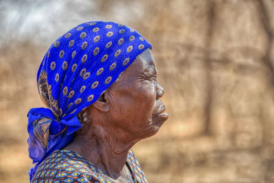 Close-up portrait of woman against blurred background