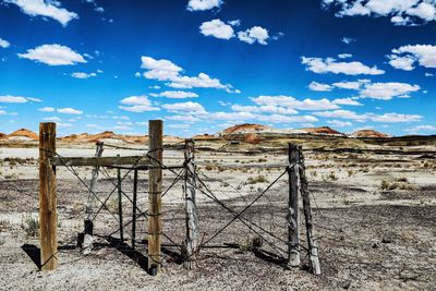 Fence on field against sky